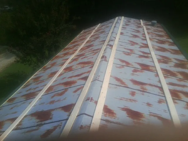 Rusted metal roof panels with new wood purlins before replacement — Storm Damage Roof Repair in Livermore by Roofing Brothers