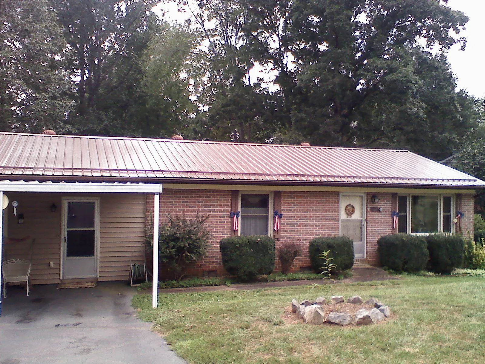Bronze metal roof and carport on a brick ranch home — Roof Repair work by our crew in Livermore